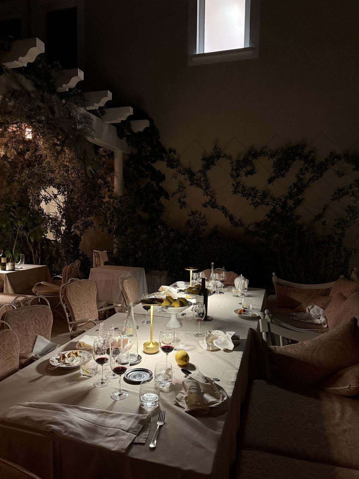 A candlelit table set for dinner at dusk