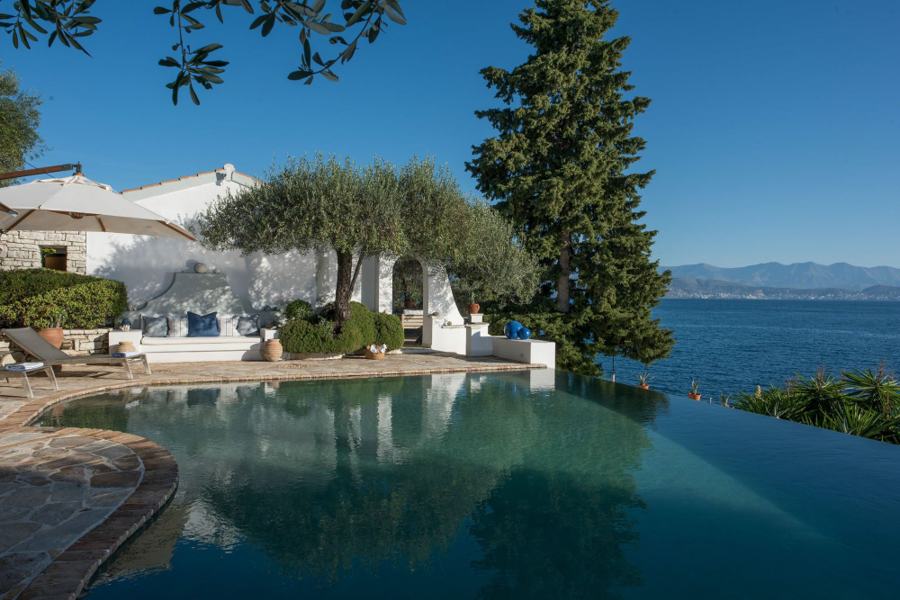 The infinity pool at Villa Yeraki, its edge meeting the Ionian sea with mountains on the far shore